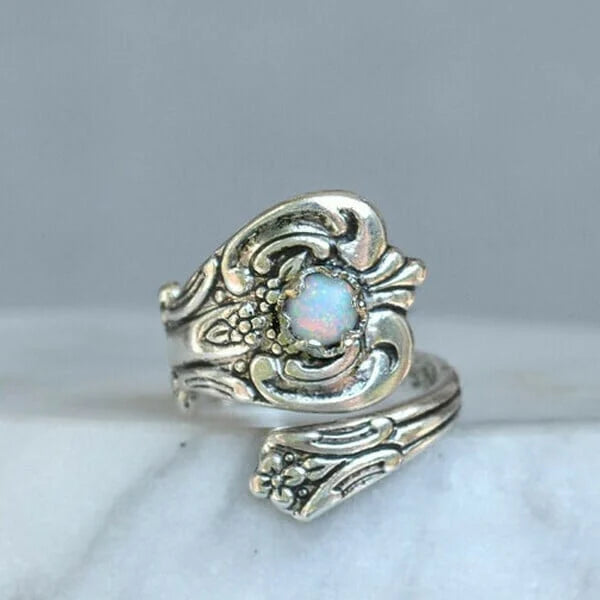 Elegant adjustable ring with a radiant white opal spoon