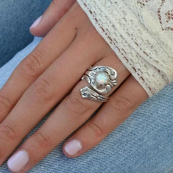 Elegant adjustable ring with a radiant white opal spoon