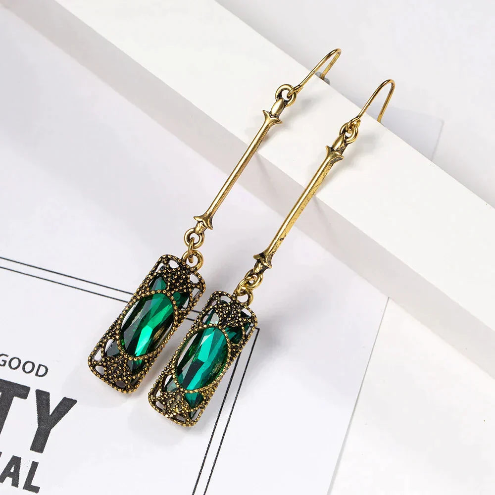 Elegant gold earrings with green lantern pendant