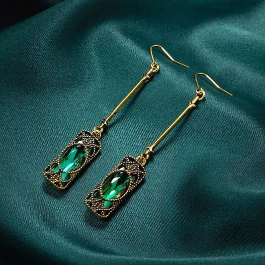 Elegant gold earrings with green lantern pendant