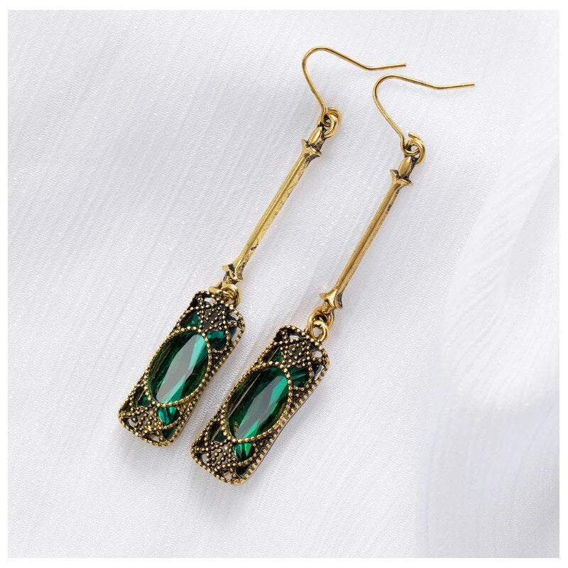 Elegant gold earrings with green lantern pendant