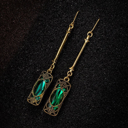 Elegant gold earrings with green lantern pendant