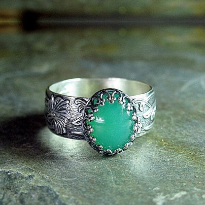 Elegant Emerald Ring with Intricate Floral Carving