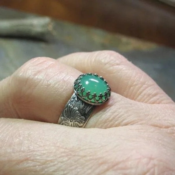 Elegant Emerald Ring with Intricate Floral Carving