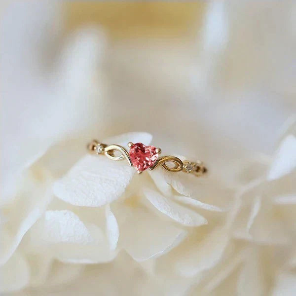 Exquisite heart ring made of gold with sparkling red zirconia