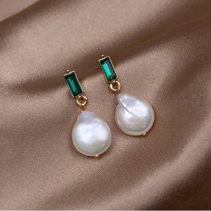 Elegant gold earrings with sparkling pearls and radiant green cubic zirconia