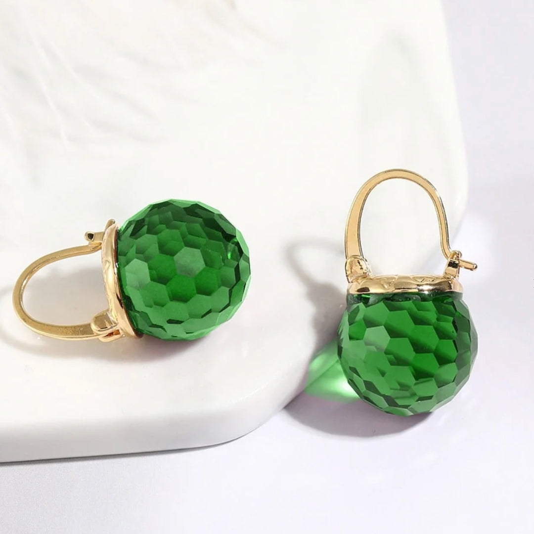 Elegant gold earrings with green crystals