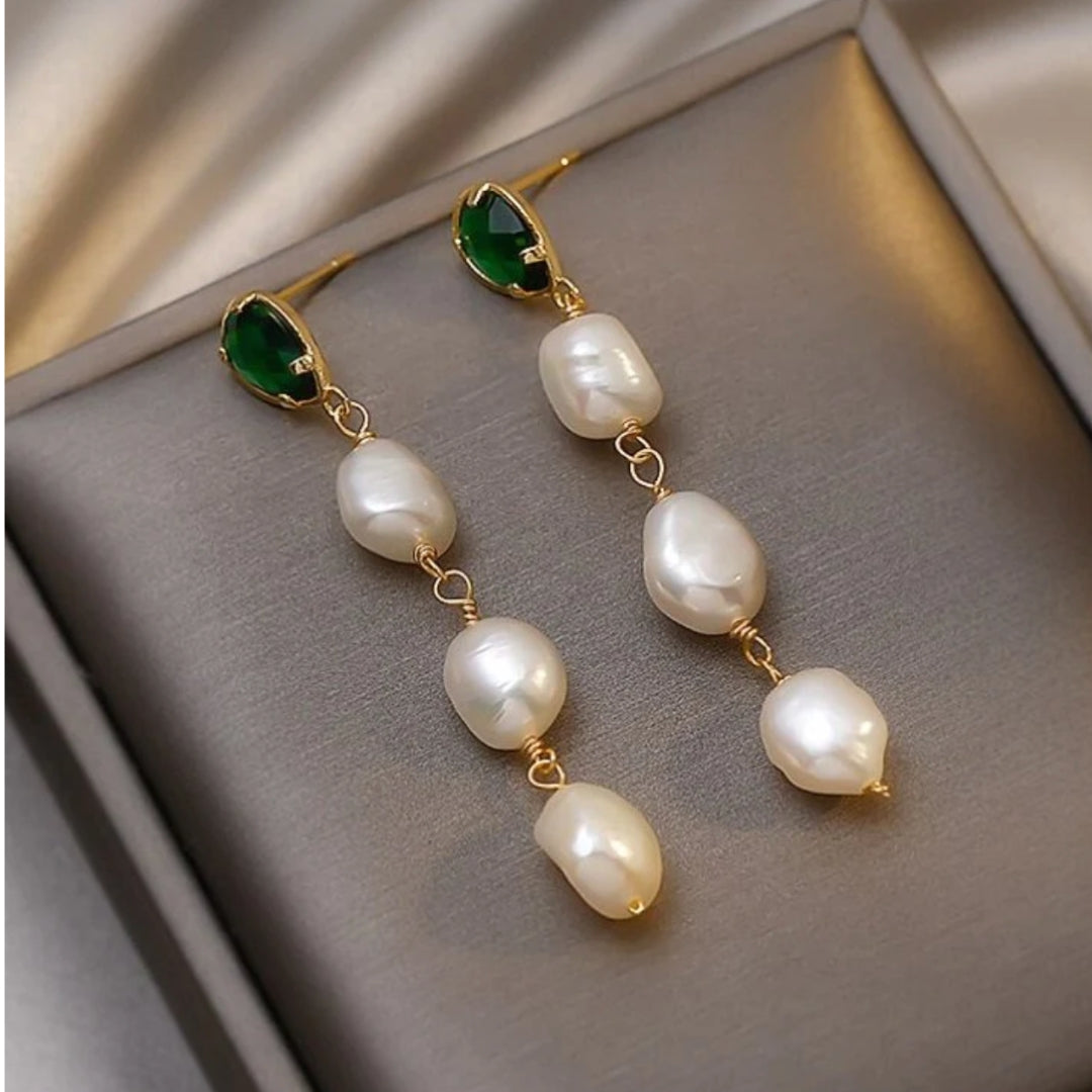 Elegant gold earrings with sparkling emeralds and delicate pearls