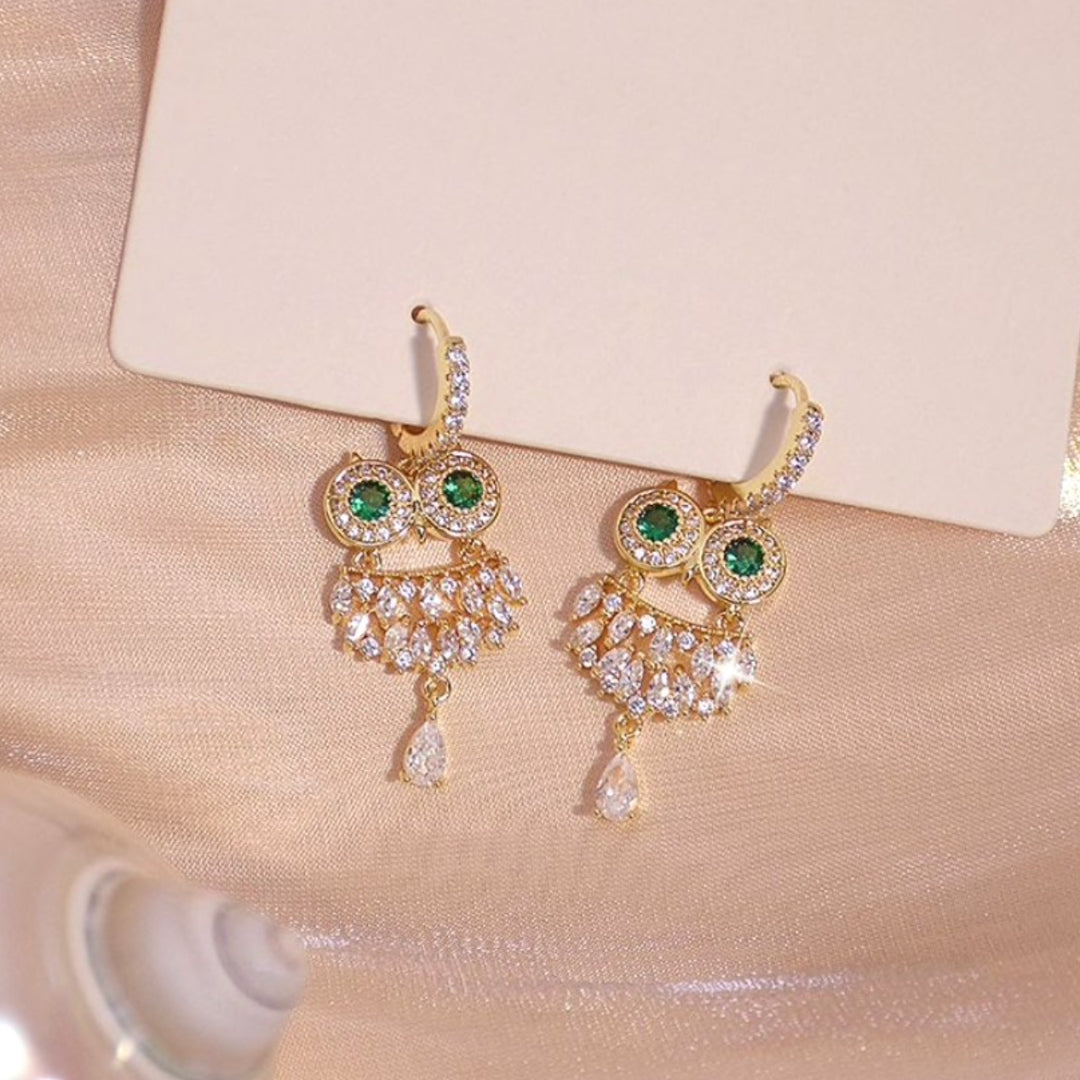 Elegant gold owl earrings with sparkling green zirconia