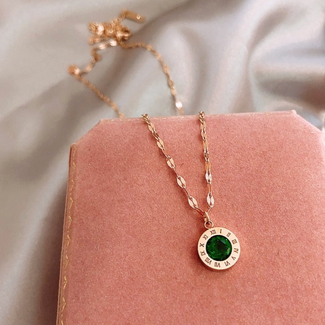 Elegant gold necklace with sparkling emerald time design