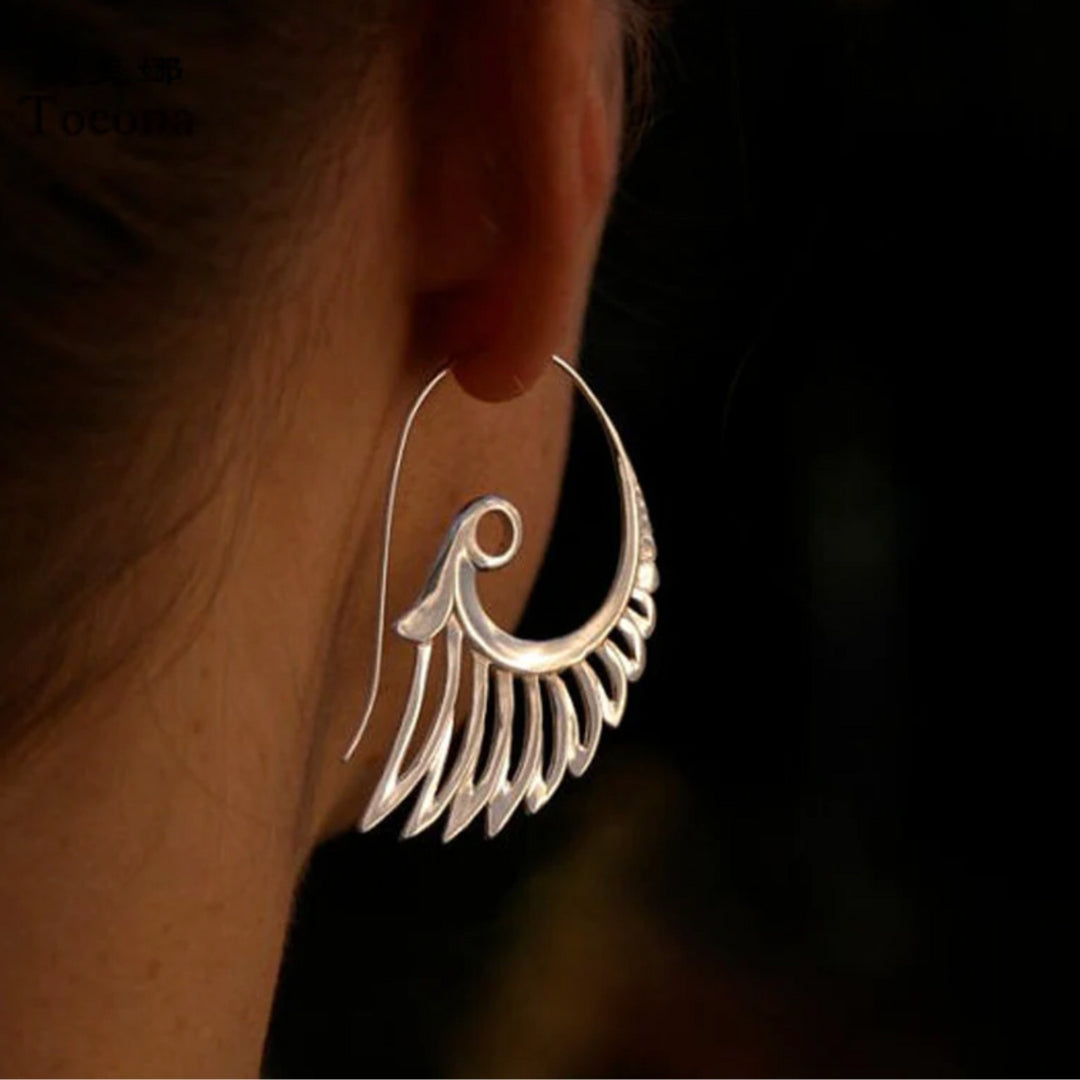 Elegant gold earrings with dreamy wing motifs