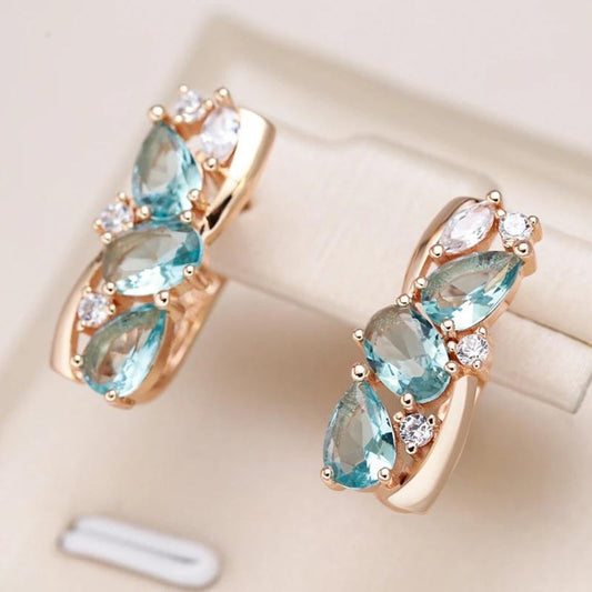 Elegant gold earrings with shimmering blue zirconia stones