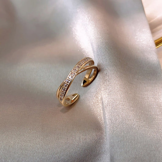 Elegant adjustable cross ring made of zirconia in a noble gold design