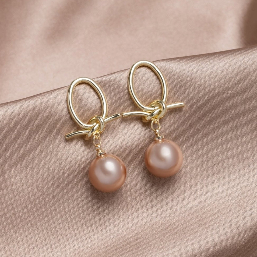 Elegant gold earrings with pearl accents