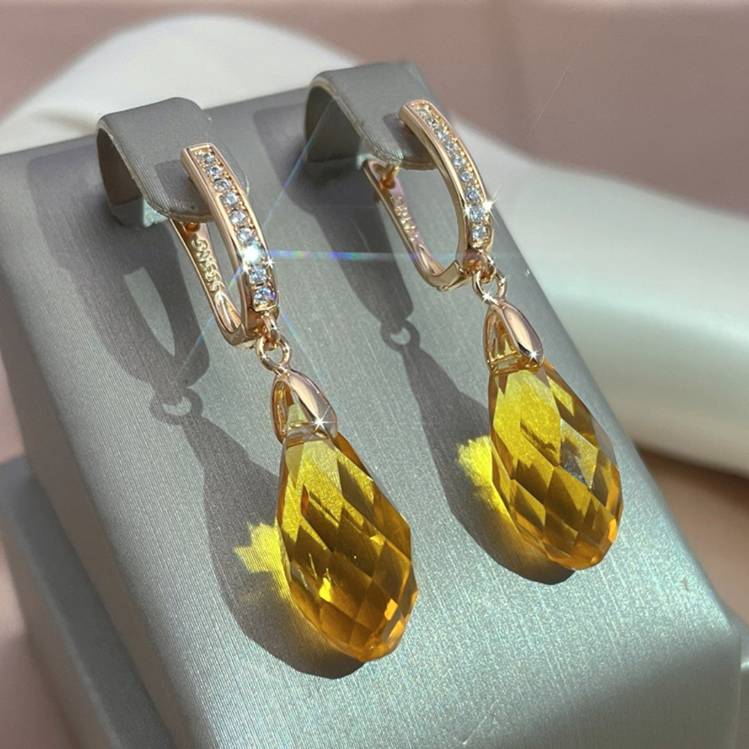 Radiant golden earrings with yellow crystal drops