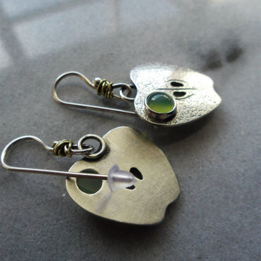 Elegant silver earrings with a radiant green crystal