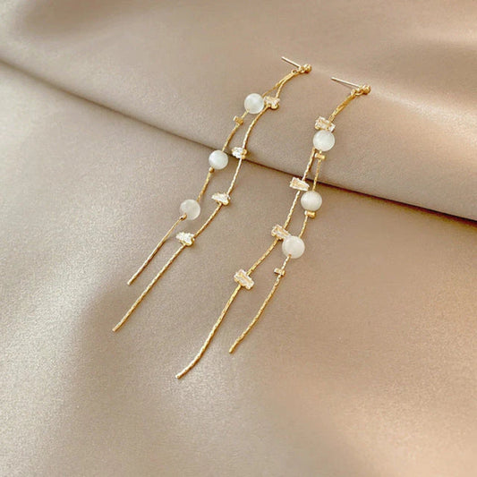 Stylish hanging earrings with sparkling pearls and zirconia stones