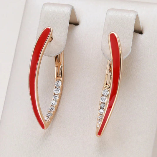 Elegant gold-plated earrings with vibrant red enamel accent