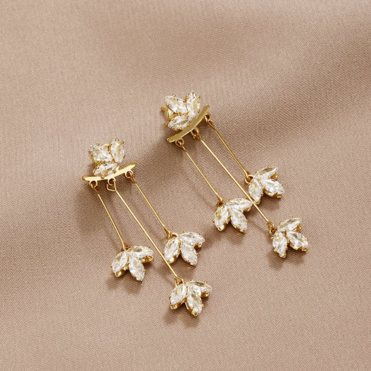 Elegant gold earrings with sparkling crystal leaves