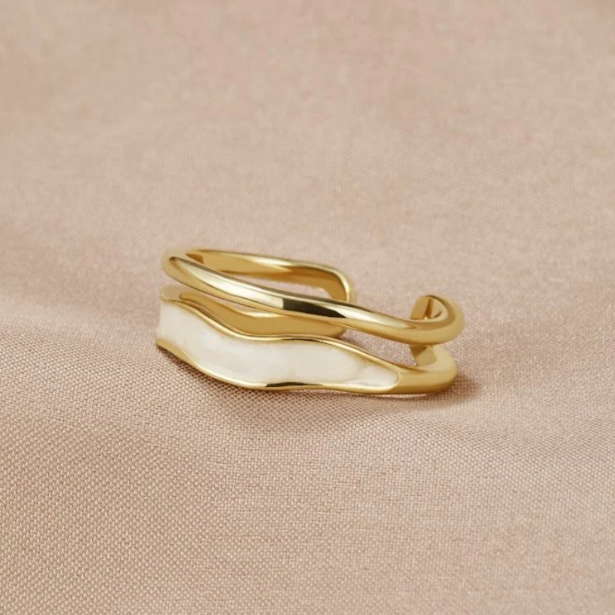 Elegant gold ring with stylish white enamel design