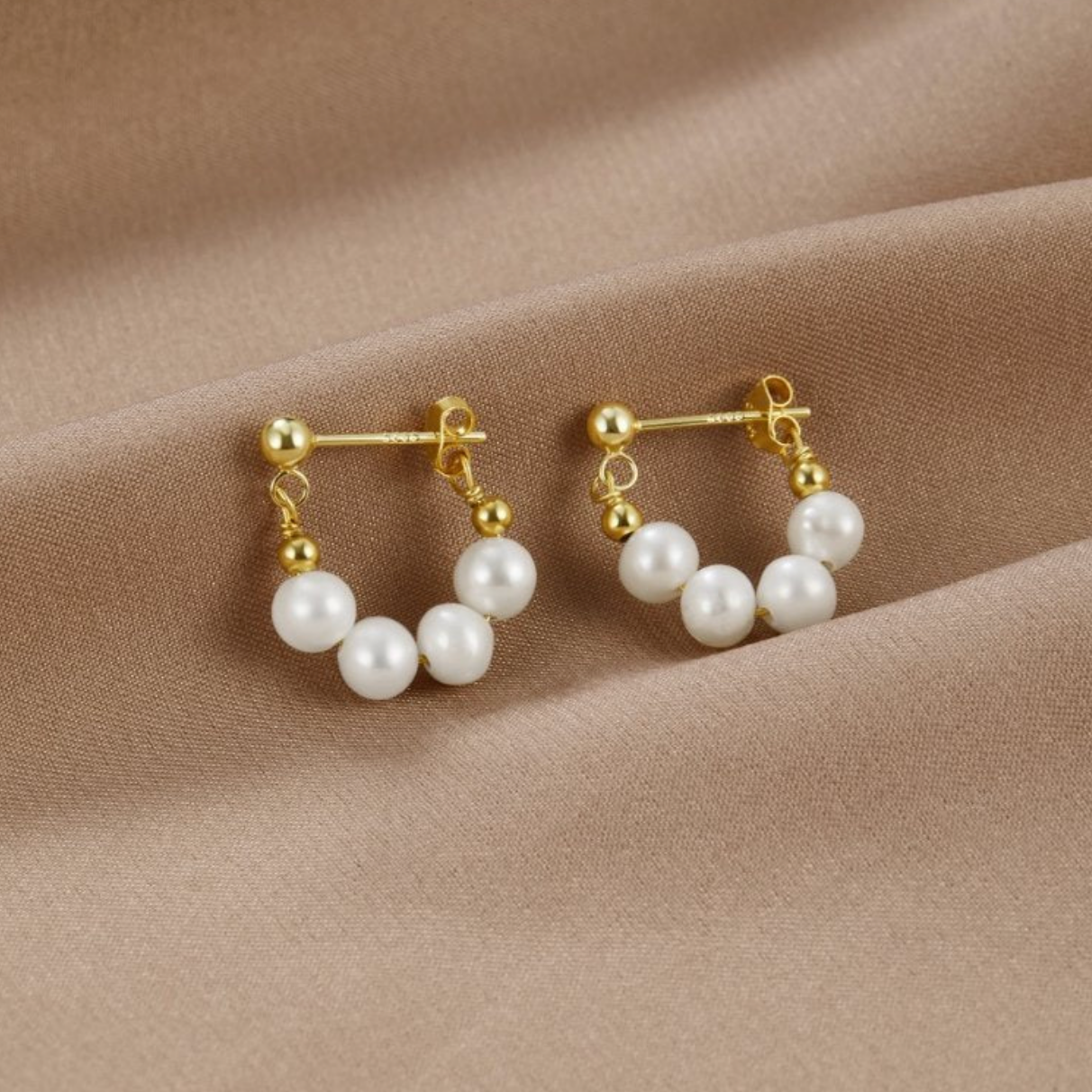 Elegant gold earrings with radiant freshwater pearls