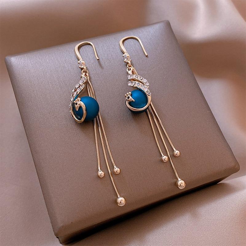 Elegant festive earrings with radiant blue pearls