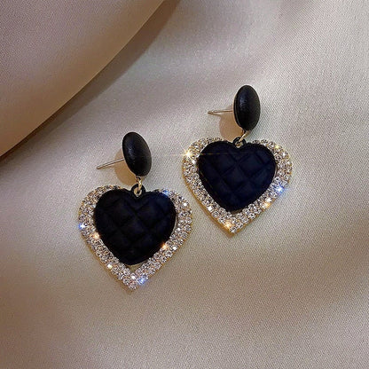 Elegant Gold Earrings with Dark Hearts