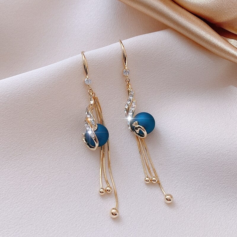 Elegant festive earrings with radiant blue pearls