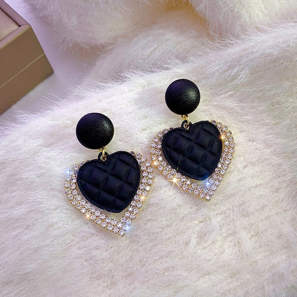 Elegant Gold Earrings with Dark Hearts