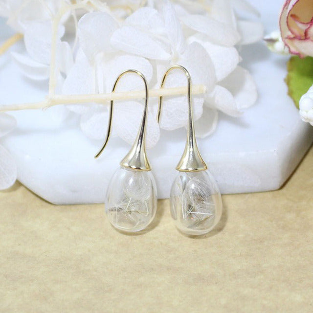 Elegant silver earrings with dandelion pendants