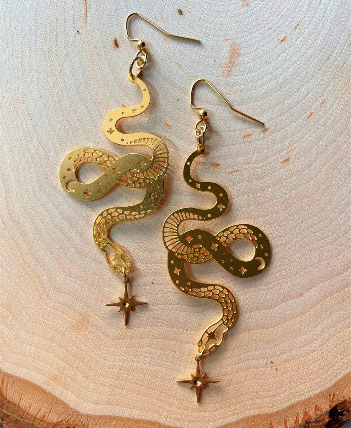Elegant gold earrings with star snake pendant