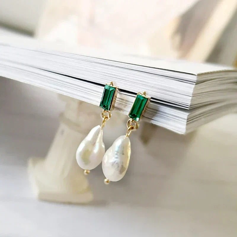 Elegant gold earrings with sparkling pearls and radiant green cubic zirconia