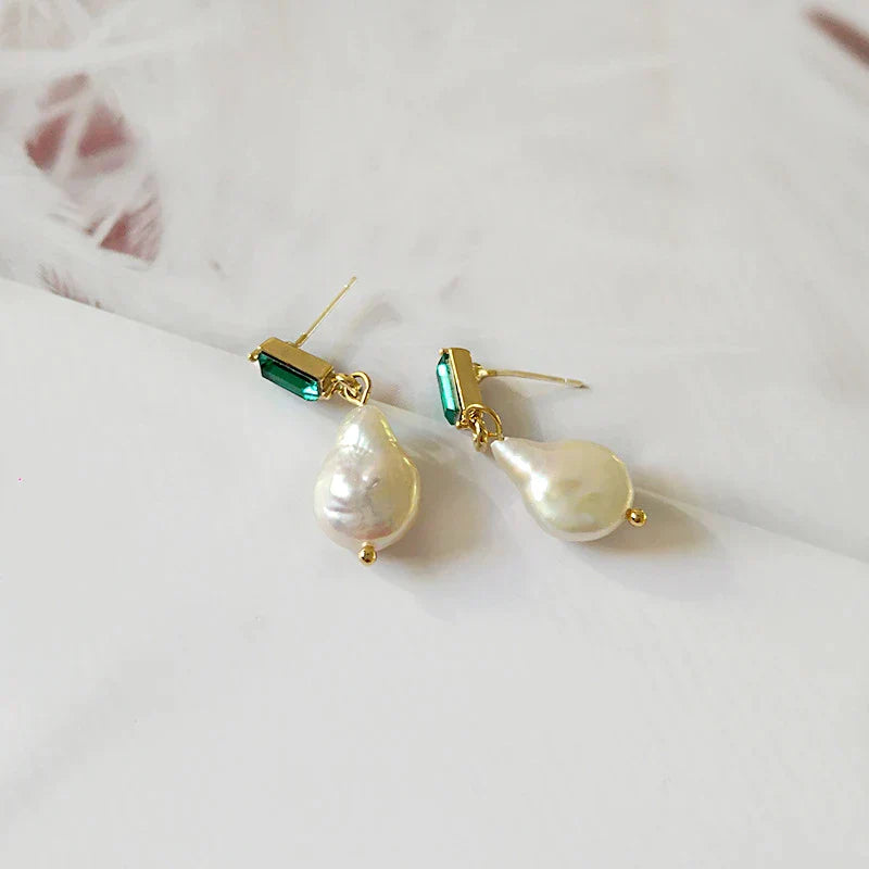 Elegant gold earrings with sparkling pearls and radiant green cubic zirconia