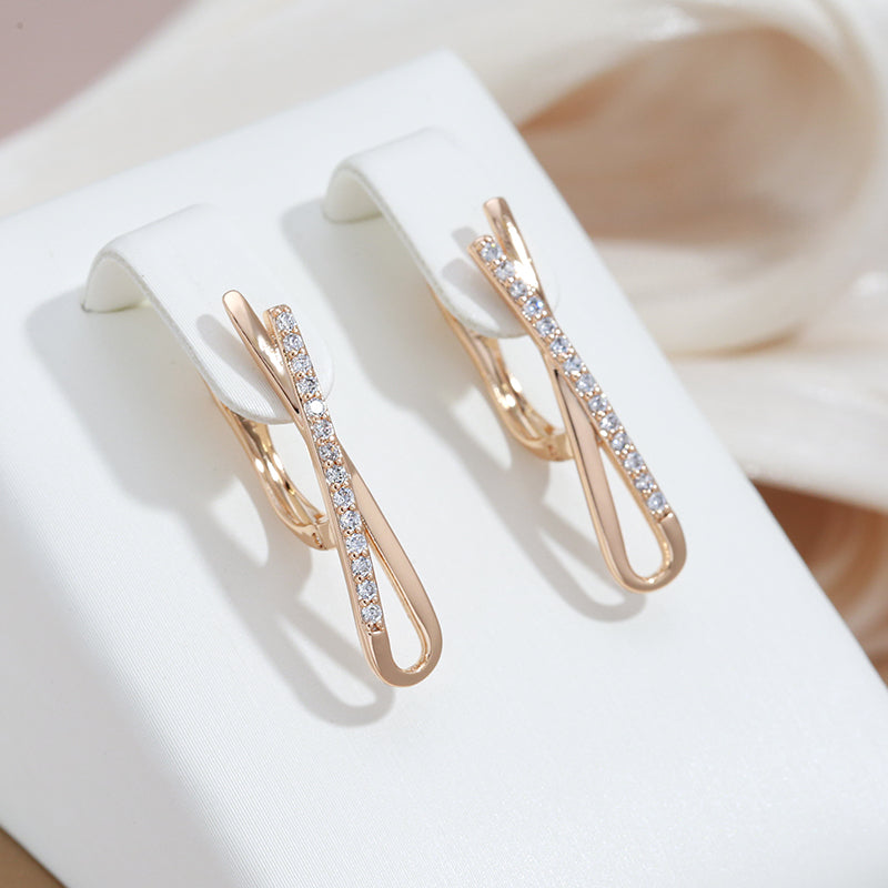 Elegant gold earrings with sparkling diamonds in a cross design