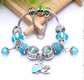 Elegant bracelet made of rose gold-colored silver with sparkling blue zirconia stones