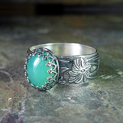 Elegant Emerald Ring with Intricate Floral Carving