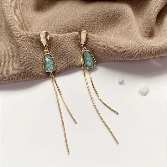 Golden earrings with radiant turquoise stone