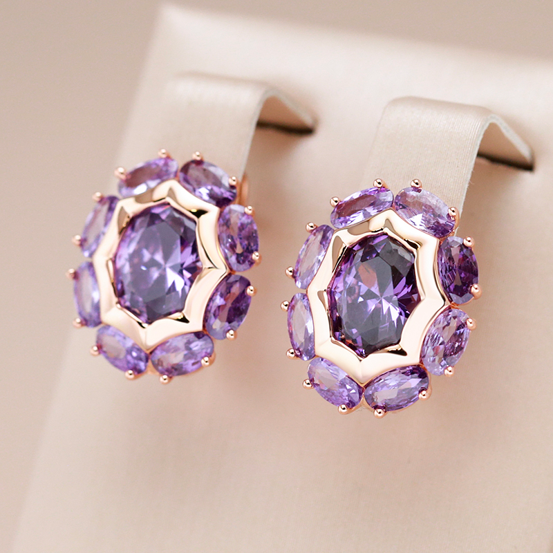 Elegant gold earrings with shimmering purple crystal flowers