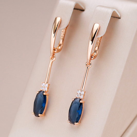 Luxurious gold earrings with sparkling blue crystals