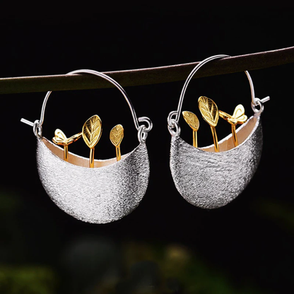 Elegant silver earrings with a gilded flower basket design