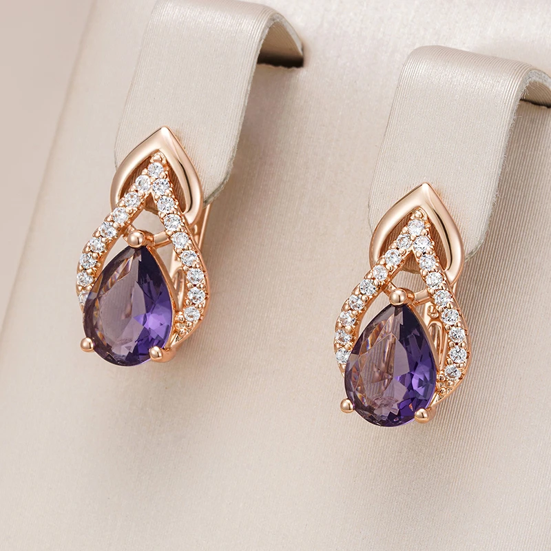 Graceful gold earrings with purple crystal drops