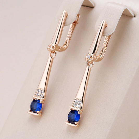 Elegant gold earrings with sparkling blue crystal pendants