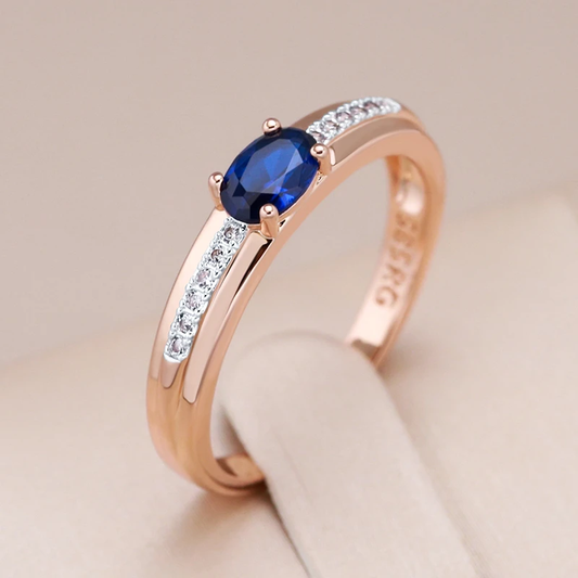 Elegant gold ring with sparkling blue crystal