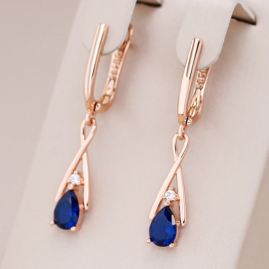 Elegant gold earrings with radiant blue pendants