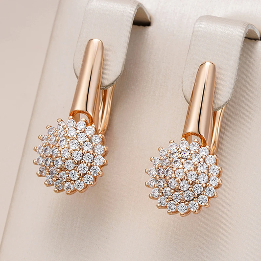 Charming golden earrings with zirconium flower design