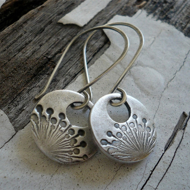 Elegant silver earrings in playful dandelion design