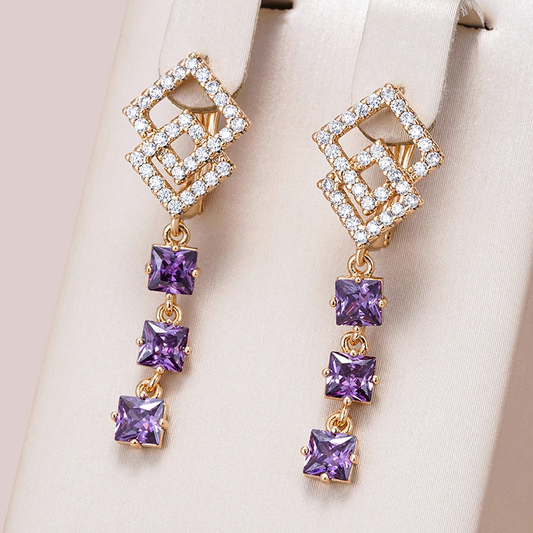 Golden stud earrings with sparkling purple crystals