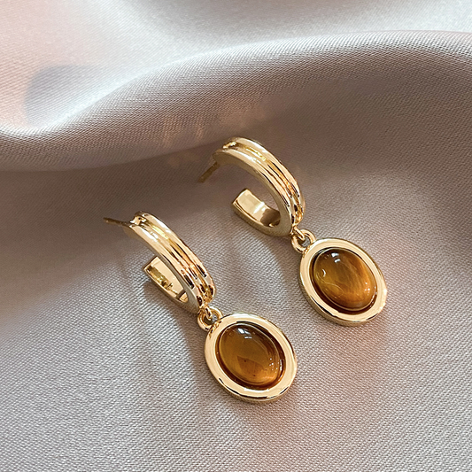 Golden earrings with radiant orange crystals