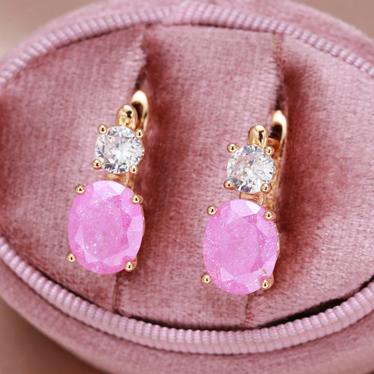 Stylish golden earrings with sparkling pink zirconia