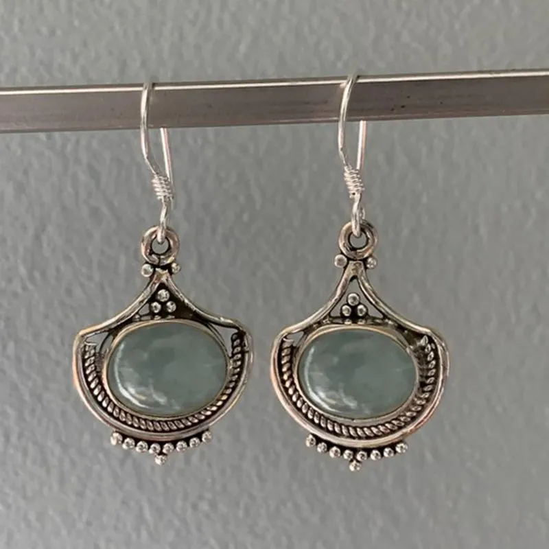 Elegant silver vintage earrings with green accent